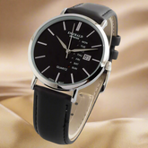 Black wristwatch with a silver case on a white background