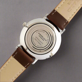 Watch with brown leather strap and visible brand name on a white background