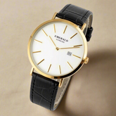 Watch with black leather strap and gold case on a white background