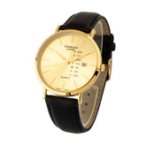 Gold watch with black leather strap on a white background
