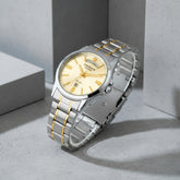 Silver and gold watch with a white background