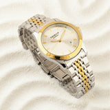 Two-tone silver and gold watch on a white background