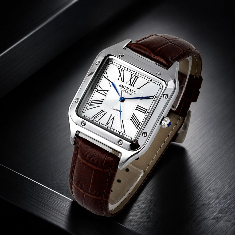 A rectangular silver-tone metal wristwatch with a white dial, Roman numeral hour markers, blue hands, and a brown leather strap, photographed on a dark brushed surface.