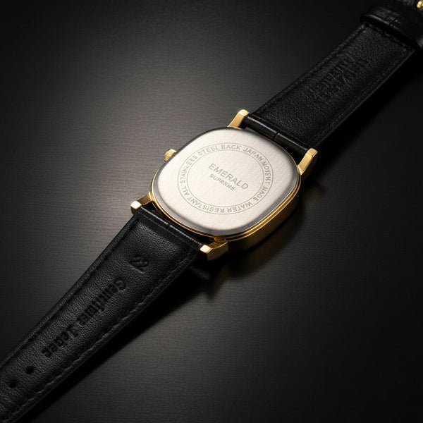 Watch with gold case and beige leather strap on a white background