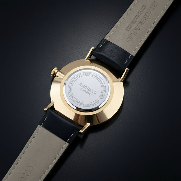 Gold watch with black strap on a white background