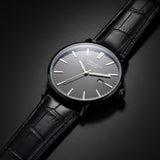 Black wristwatch with a dark face on a white background