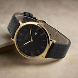 Black watch with gold accents on a white background